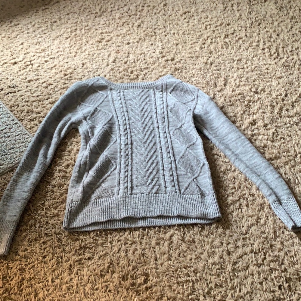 I’m selling a gray knitted sweater.